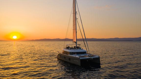 Sunreef 60 Vulpino cruising peacefully off Kastela during a golden sunset.