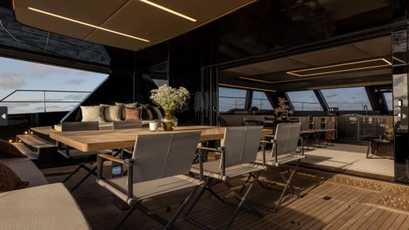 Amber One features a stylish dining table and cozy lounge at the aft deck near Kastela.
