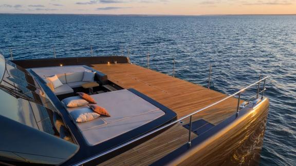 The spacious aft deck of Amber One offers a relaxing spot during sunset near Kastela.