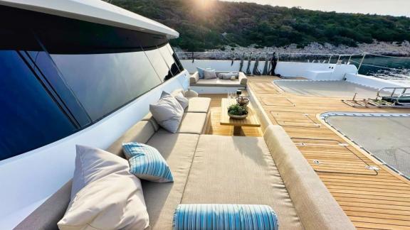 Spacious cushioned seating on Honeybird offers a luxurious and cozy charter spot in Šibenik’s bays.