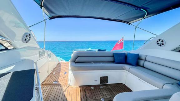 Anchored off Ibiza, the Fancy It yacht features a cozy aft seating space with beautiful sea views.