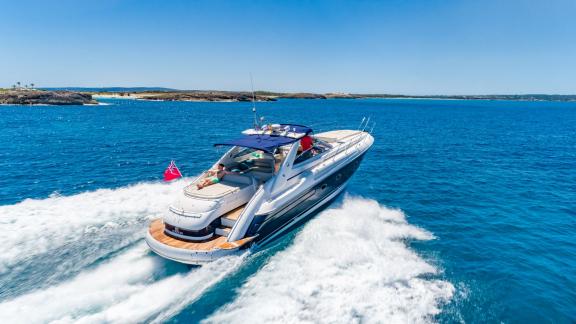 Fancy It speeds through Ibiza waters with a person sunbathing on the aft deck.