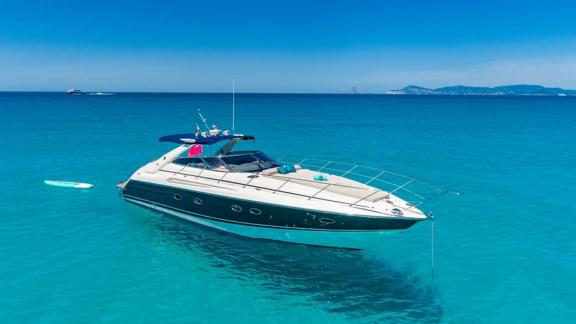 Fancy It motor yacht anchored in turquoise waters