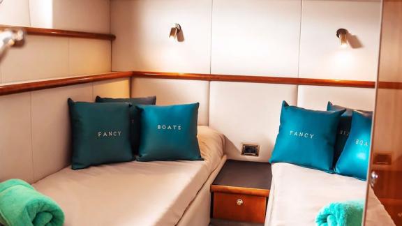 The twin cabin on Fancy It yacht anchored in Ibiza offers cozy sleeping space.