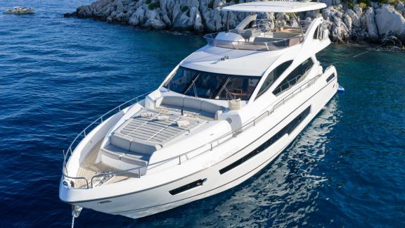 The Sunseeker 75 floats peacefully near the rocky shores of Split in stunning clarity.