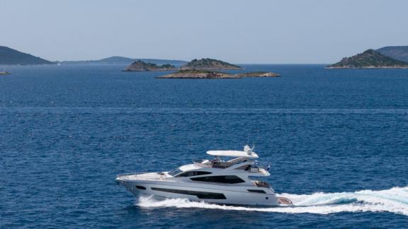 The Sunseeker 75 luxury yacht speeds across the Adriatic near Split with scenic islands in the background.