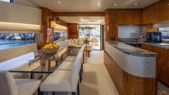 Sunseeker 75 features a spacious salon with dining area and modern kitchen while anchored near Split.
