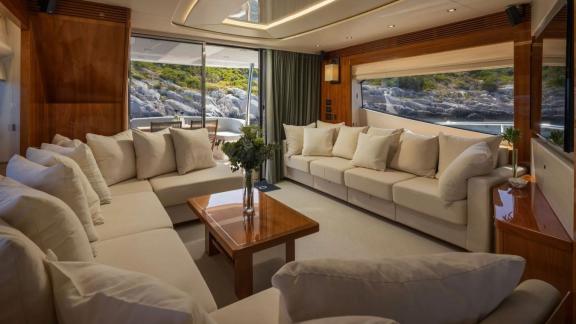 Sunseeker 75 features a spacious salon with dining area and modern kitchen while anchored near Split.