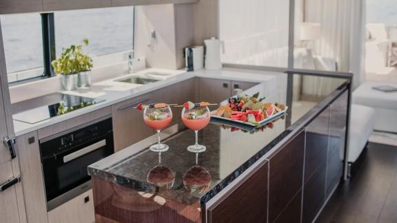 The kitchen of Lady M in Mallorca features drinks, fruit service and a full countertop.