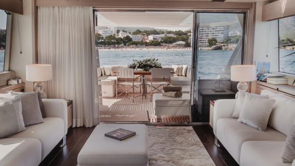 The salon of Lady M in Mallorca opens to the aft deck, both areas seen together.