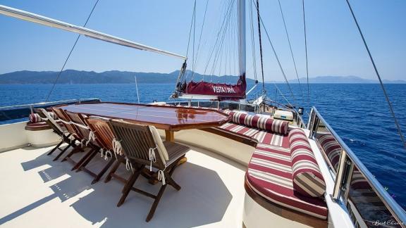 Dining area on the deck of the gulet Vesta 1 Sevil, with stylish seating and sea views.