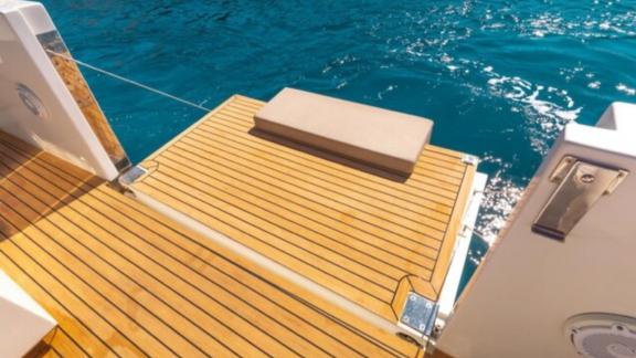 The wooden aft platform of motor yacht Cea 3 provides easy access to the sea.