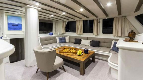 Elegant and cosy living area of the sailing yacht The Blue Sea with seating area and coffee table.