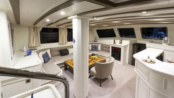 Spacious saloon of the sailing yacht The Blue Sea with comfortable seating.