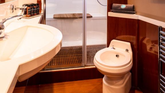 The bathroom of the yacht Azure features a modern shower and high-quality accessories, offering a luxurious design.