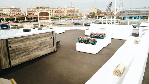 The spacious seating area on Harmony II motor yacht offers a perfect spot for outdoor relaxation.