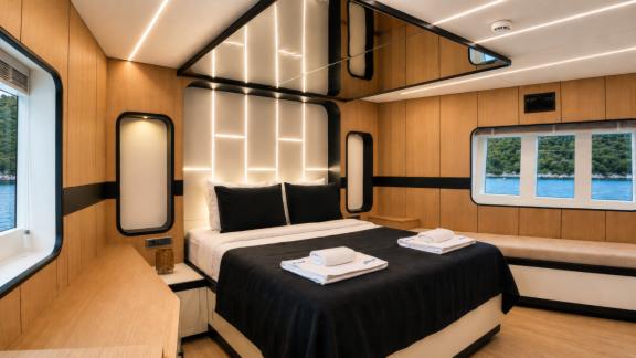 The master cabin of Beluga 1 in Göcek features a large bed, panoramic windows and a comfortable living space.
