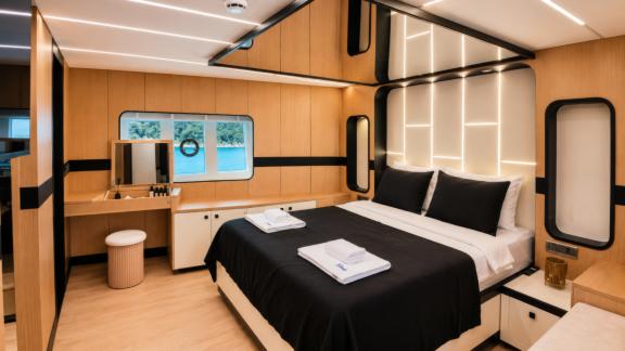 The master cabin of Beluga 1 in Göcek features a large bed, vanity area and scenic sea views.