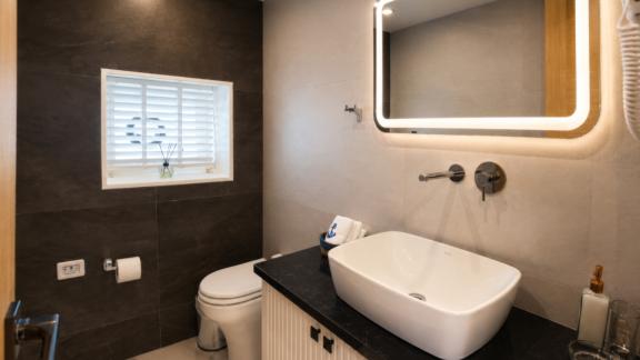 The private bathroom of Beluga 1 in Göcek features a modern sink unit and elegant interior details.