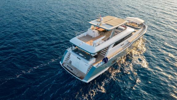 The aft deck of the Floki trawler yacht offers a stunning view of the open sea in the evening.