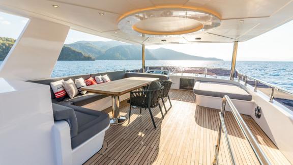 Großer und komfortabler Sitzbereich auf dem Oberdeck der Trawler-Yacht Floki mit Meerblick.