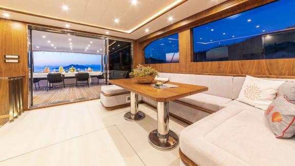 The door from the seating area to the deck of Floki trawler yacht offers a spacious and comfortable atmosphere.