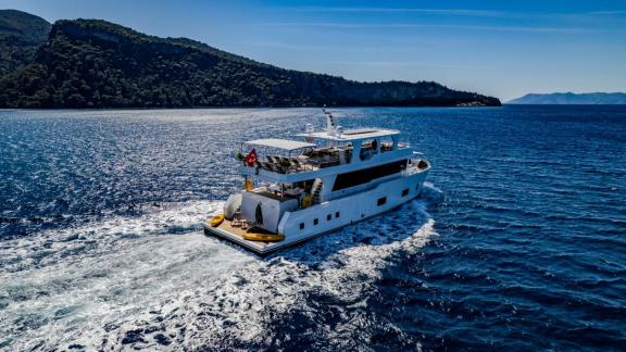 Lila trawler yacht moves smoothly with spacious aft deck near the coast of Fethiye.