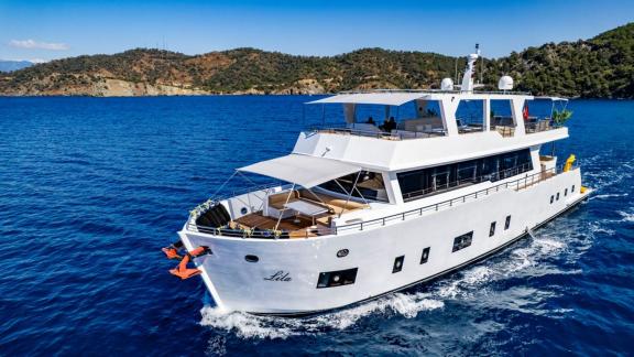 Lila trawler yacht moves smoothly with spacious decks near the coast of Fethiye.