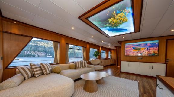 Large corner sofas and sea view windows in salon of Lila yacht near Fethiye.
