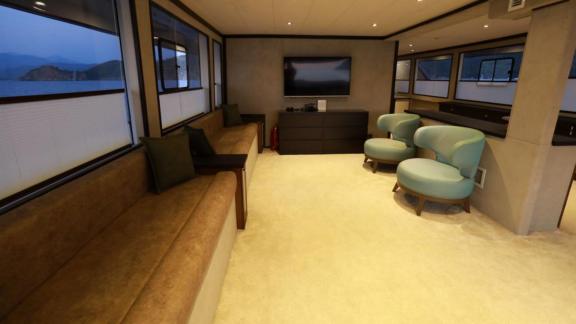 Comfortable interior seating area of the trawler Nayk 3 with a wide sofa and scenic windows.