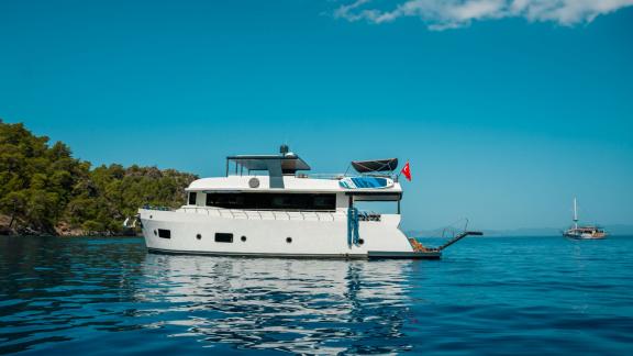 The Oggusto trawler yacht is anchored in the calm waters off Fethiye.