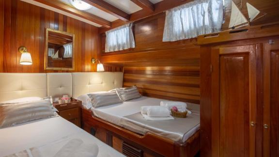 Double bed cabin with wooden paneling and stylish lighting. Perfect for a relaxing holiday.