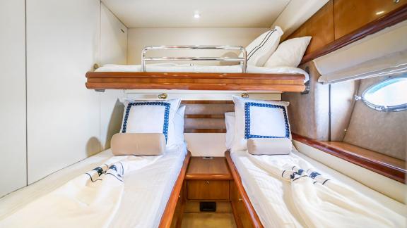 The spacious cabin on the Edition yacht with three beds offers comfortable sleeping arrangements and ample storage space