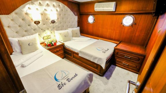 A comfortable twin-bed cabin of the Gulet Efe Burak with luxurious details.