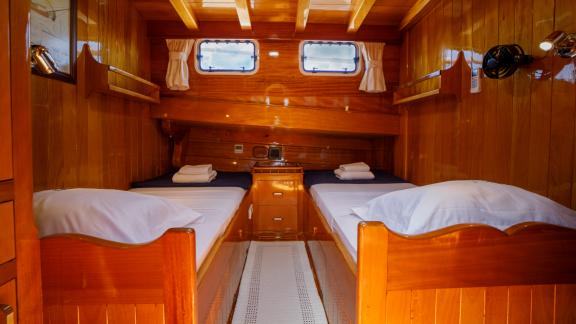 Experience comfort in the cozy twin cabin of Gulet Ya Selam with elegant wood design.