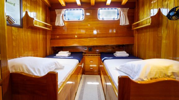 Enjoy the comfortable twin cabin of Gulet Ya Selam with stylish wooden interior.