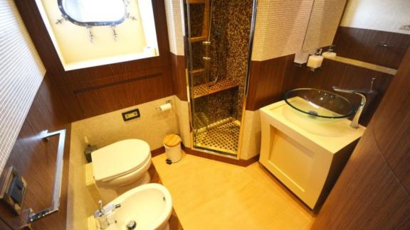 Stylish bathroom with shower and elegant amenities on a motor yacht.