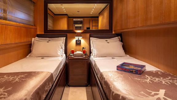 Cosmos yacht’s twin cabin blends comfort, wood tones, and relaxing ambiance perfectly.