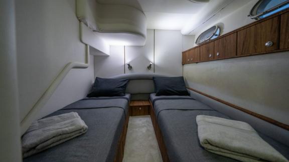 The guest cabin of Karan motor yacht features twin beds and ample storage for comfortable accommodation.