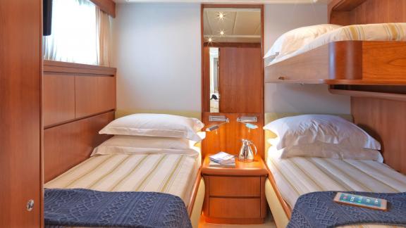 Cozy bunk bed cabin on the 30-meter Motor Yacht Martina, ideal for families in Greece.