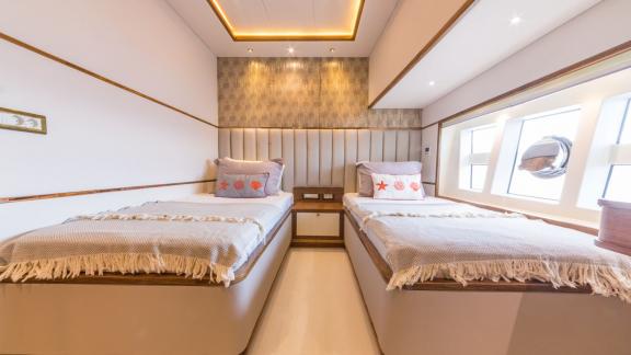 Twin-bed cabin on the Floki trawler yacht, featuring stylish and cozy design.