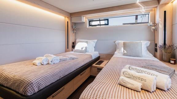 The twin cabin of the White Caps catamaran features a simple and comfortable design.