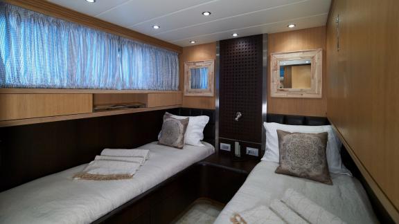 The twin bed cabin on Lady KC offers comfort and stylish design for a relaxing stay.