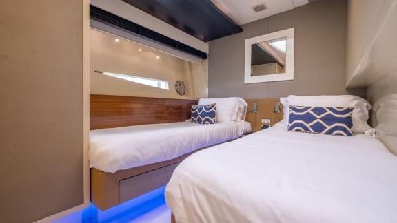 The twin guest cabin of motor yacht Funky Town features comfortable beds and an elegant design.