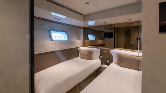 The spacious guest cabin of San Lorenzo Sx88 ensures comfort for your hourly yacht rental experience in Dubai.