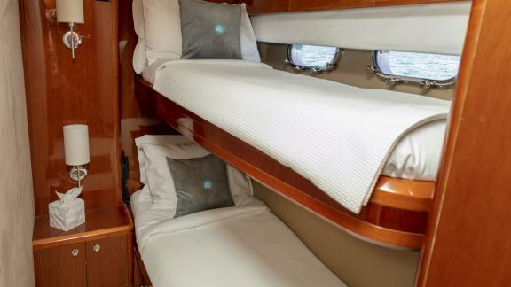 The guest cabin of the yacht Azure is equipped with comfortable bunk beds.