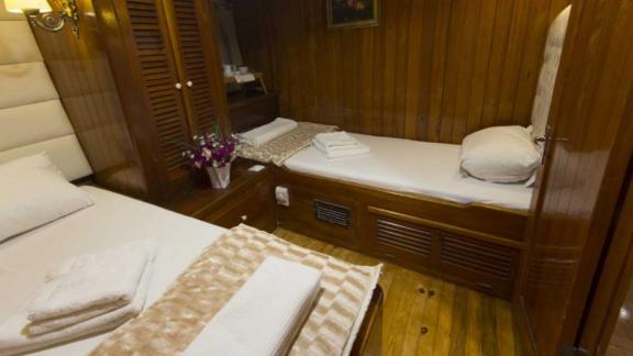 Cabin with a double and single bed, perfect for groups or families on board the Gulet Hera.