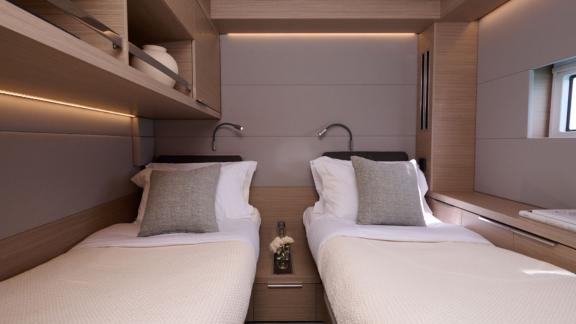 The guest cabin of Dream catamaran offers two single beds, warm lighting and wooden accents for a cozy feel.