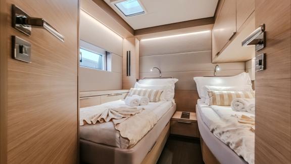 This twin cabin features a sleek modern design, smart storage, and a cozy, relaxing feel.