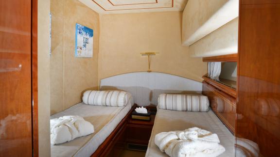 Comfortable guest cabin with two single beds on the yacht Kentavros 2, offering a pleasant stay.